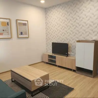 Modern living room with stylish decor and wooden furniture, featuring a sleek TV stand and contemporary artwork.