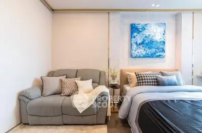Modern bedroom with cozy sofa and stylish decor in a chic apartment.
