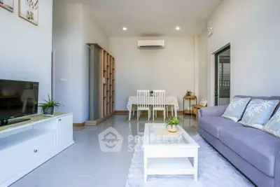 Bright and modern living room with sleek furniture and air conditioning.