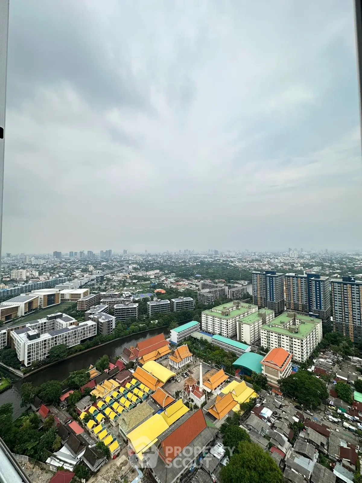 Stunning aerial view of urban landscape with vibrant rooftops and sprawling cityscape.