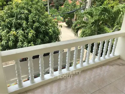 Charming balcony with lush garden view, perfect for relaxation and enjoying nature's tranquility.