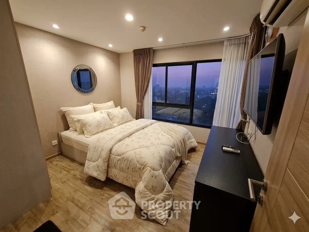 Cozy bedroom with city view, modern decor, and elegant furnishings