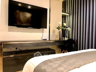 Modern bedroom with sleek TV and stylish desk setup