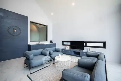 Modern living room with sleek blue furniture and minimalist decor