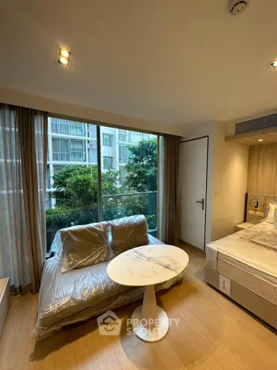 Modern bedroom with large window and stylish furniture in urban apartment