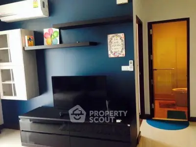 Modern living room with sleek TV unit and vibrant wall decor