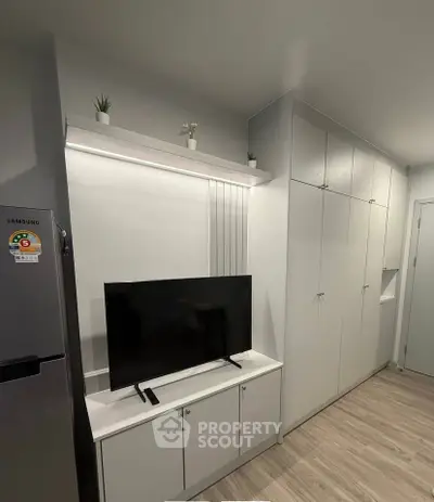 Modern living room with sleek TV unit and ample storage cabinets