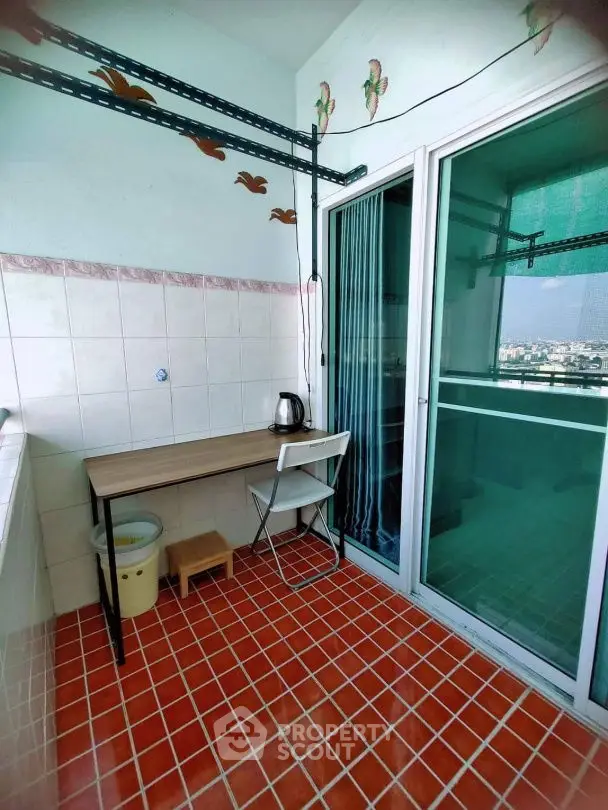 Charming balcony with city view, tiled floor, and cozy seating area.