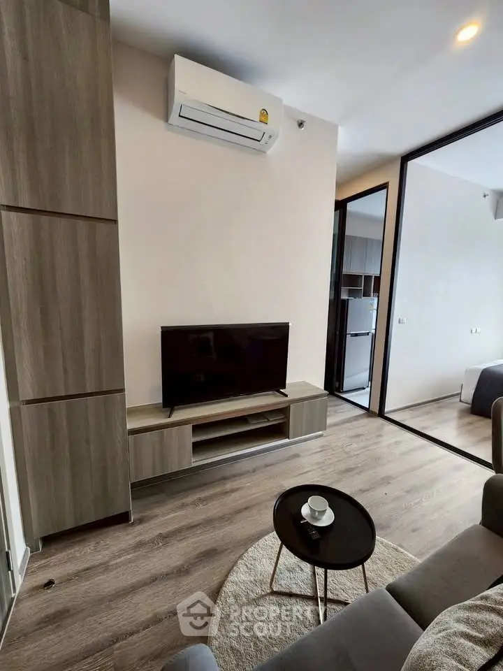 Modern living room with sleek furniture and air conditioning in a stylish apartment.