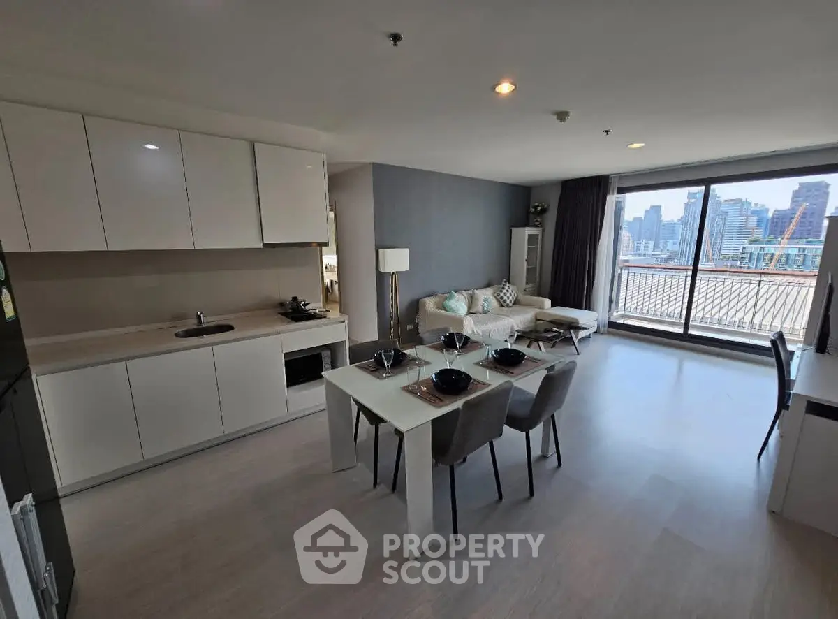 Modern open-plan kitchen and living room with city view balcony