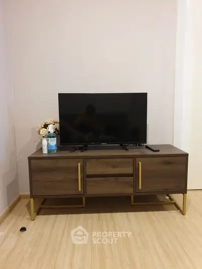 Modern living room with stylish TV stand and flat-screen TV, perfect for cozy entertainment nights.