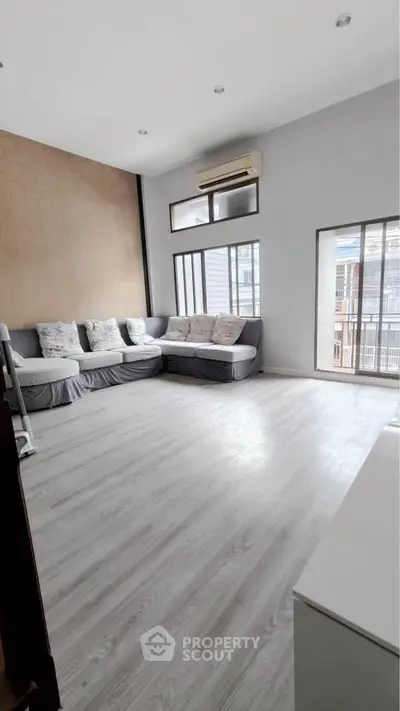 Spacious living room with modern decor and large windows for natural light.