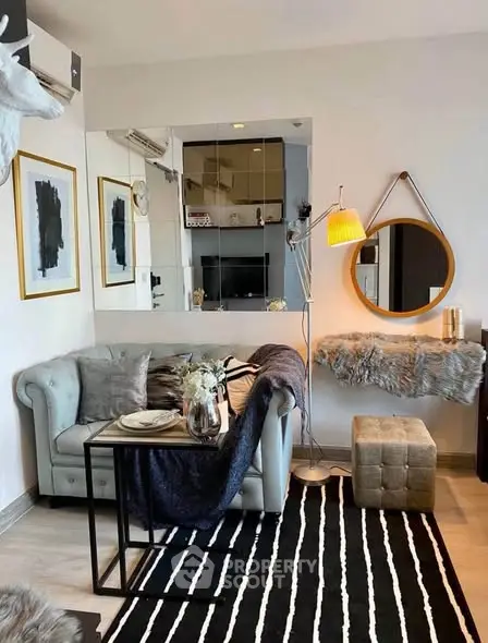 Stylish living room with modern decor, cozy seating, and elegant lighting in a chic apartment.