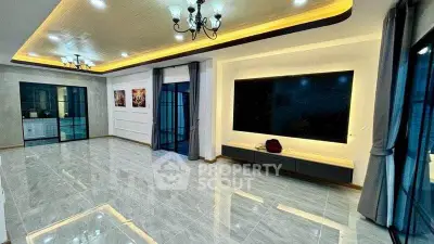 Spacious modern living room with elegant lighting and large windows.