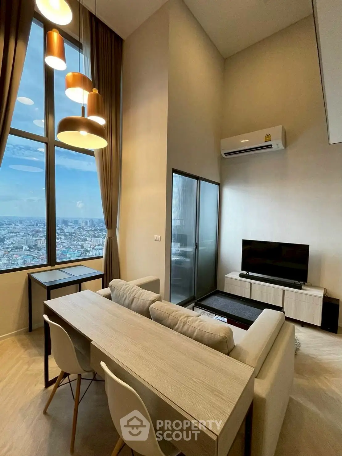 Modern living room with high ceilings and stunning city view