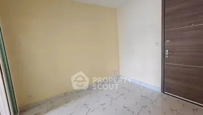 Minimalist empty room with marble flooring and wooden door, perfect for customization.