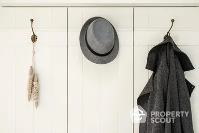 Stylish entryway with coat hooks and hat for modern home decor