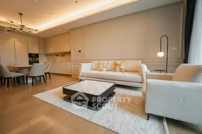 Luxurious modern living room with open kitchen, elegant furniture, and ambient lighting.