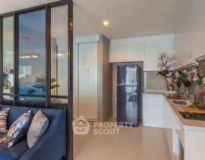 Modern open-layout kitchen with sleek appliances and stylish decor in a contemporary apartment.