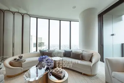 Luxurious modern living room with panoramic city views and elegant curved sofa.