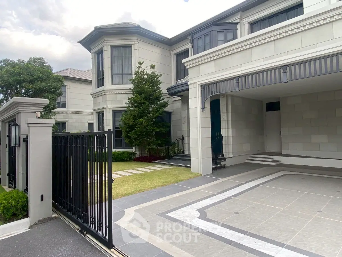 Elegant modern house exterior with spacious driveway and lush greenery