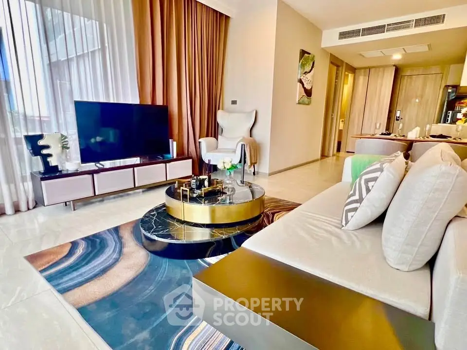 Luxurious modern living room with elegant decor and large TV, perfect for relaxation and entertainment.