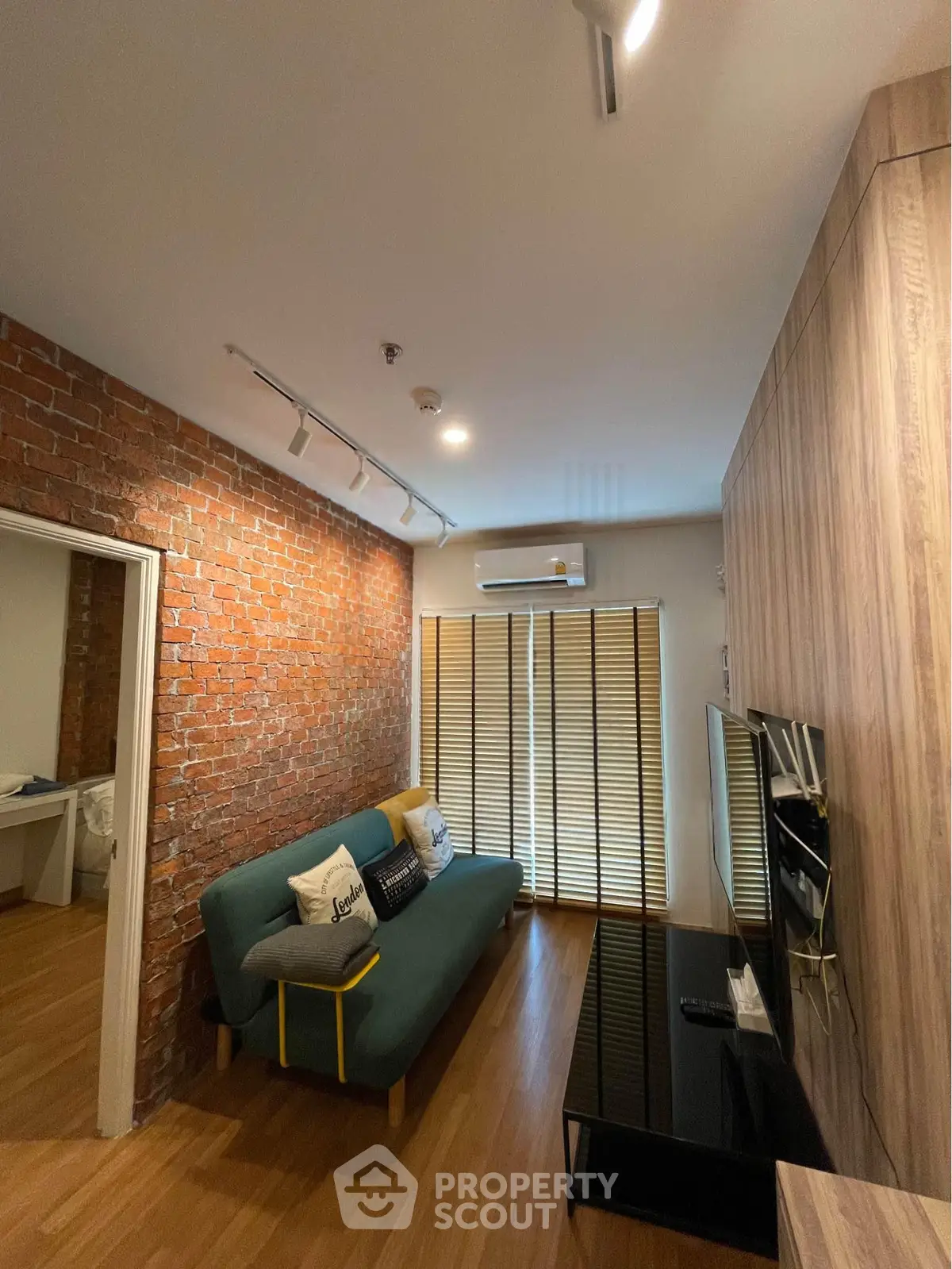 Stylish living room with exposed brick wall and modern furnishings