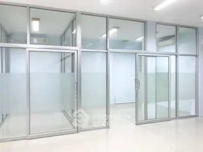 Modern office space with glass partitions and bright lighting