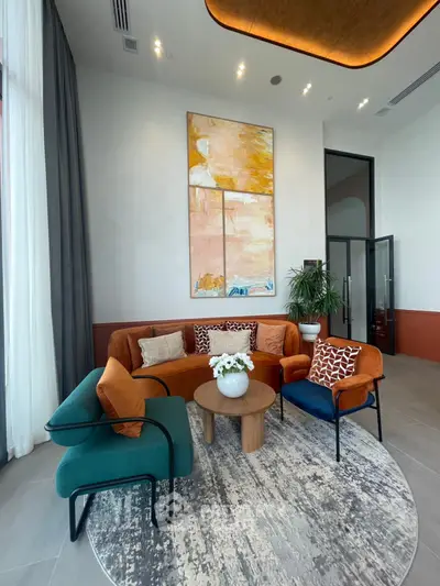 Stylish modern living room with vibrant furniture and abstract art, perfect for contemporary urban living.