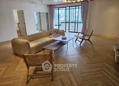 Spacious modern living room with elegant parquet flooring and city view balcony.