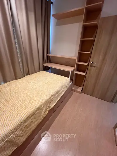 Cozy bedroom with built-in storage and wooden flooring