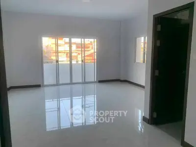 Spacious empty room with large windows and glossy tiled floor, perfect for customization.