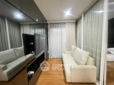 Modern living room with sleek design and floor-to-ceiling windows