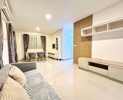 Spacious modern living room with elegant decor and ample natural light.