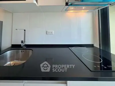 Modern kitchen with sleek black countertop and electric cooktop