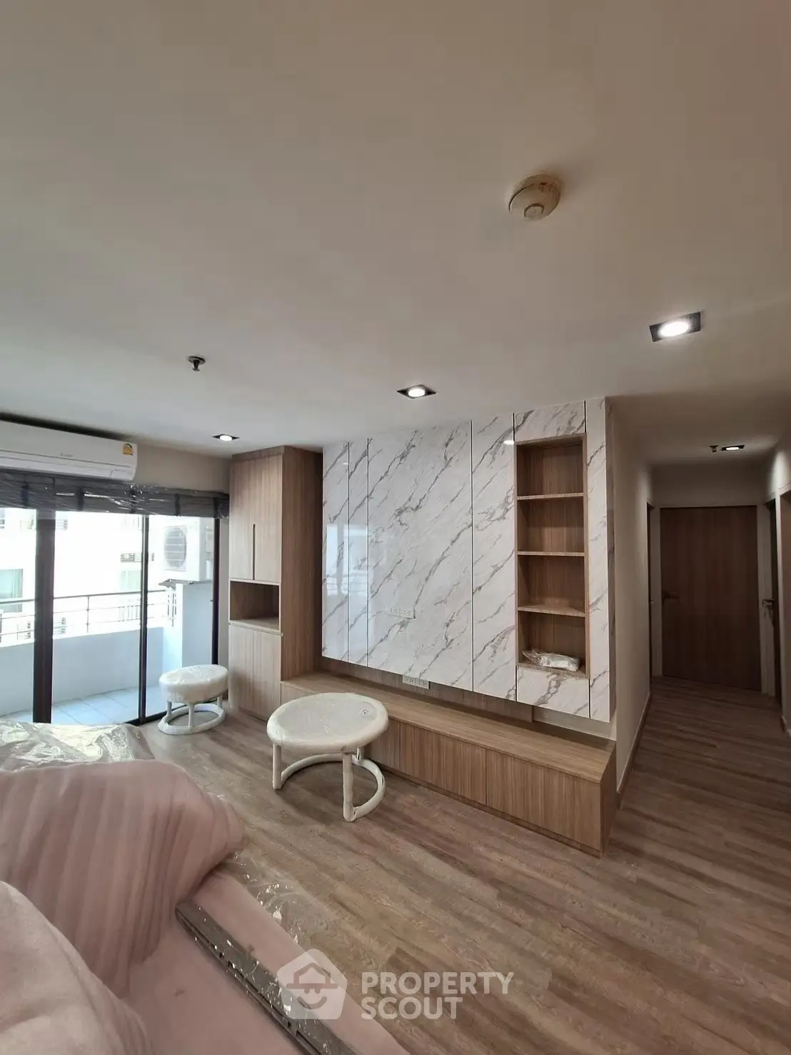 Modern living room with elegant marble wall and cozy seating area