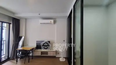 Modern living room with air conditioning and balcony access in stylish apartment.