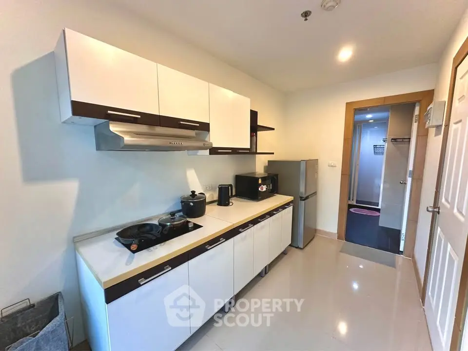 Modern kitchen with sleek cabinets and appliances in a stylish apartment