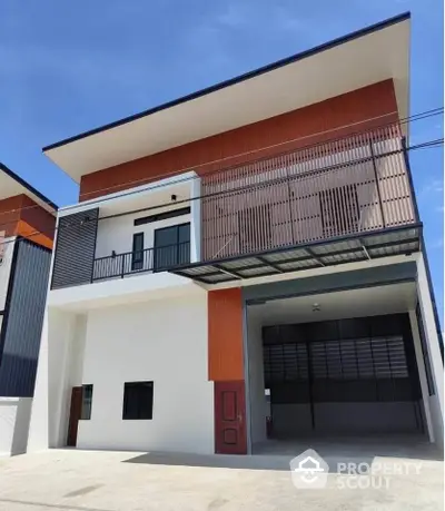 Modern three-story building with unique architectural design and spacious garage