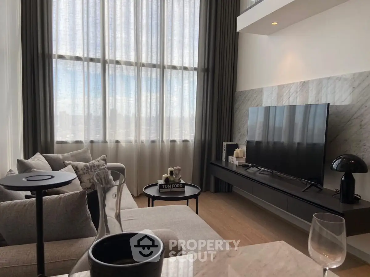 Luxurious modern living room with high ceilings and large windows offering stunning city views.