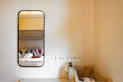 Modern bedroom with stylish mirror and cozy bed setup