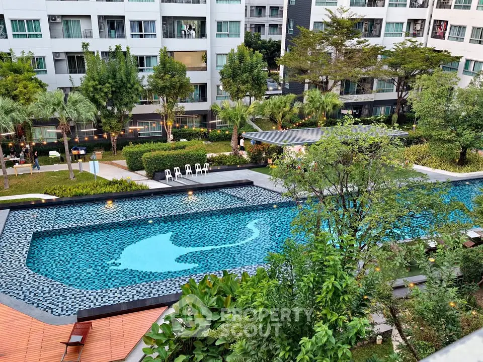 Luxurious condominium with stunning pool and lush garden view, perfect for modern living.