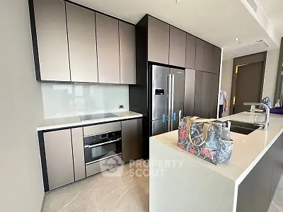 Modern kitchen with sleek cabinetry and stainless steel appliances in a luxury apartment.