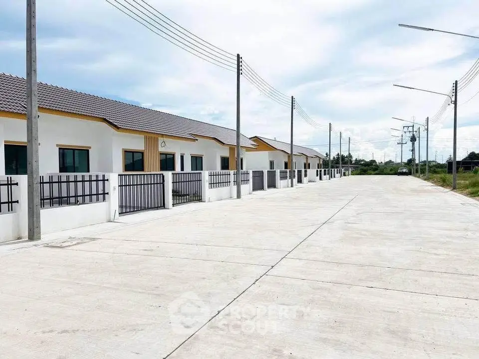 Modern row of single-story homes with clean lines and spacious driveways in a serene neighborhood.