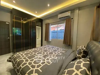 Modern bedroom with stylish decor and ample natural light