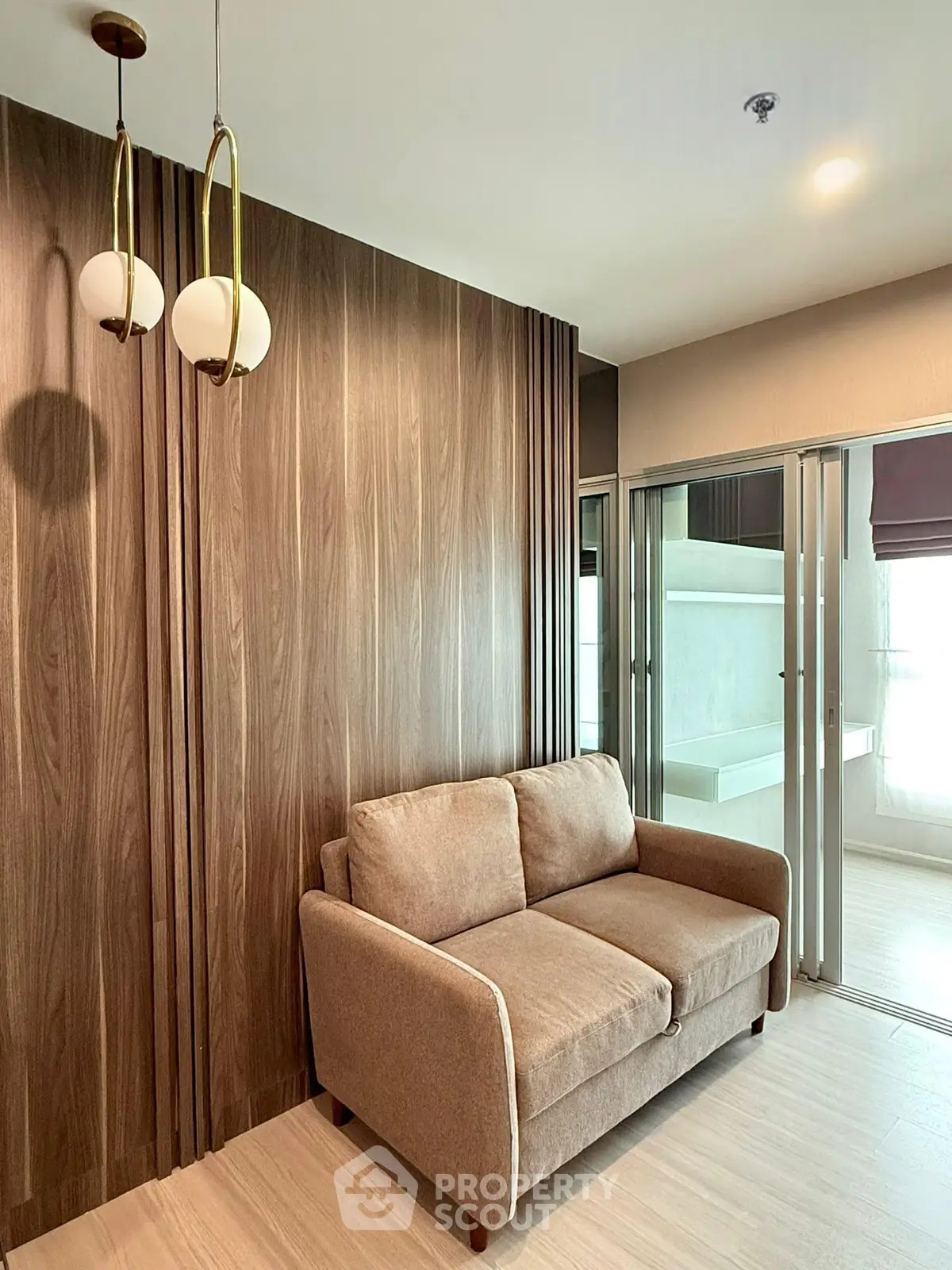Modern living room with stylish wood paneling and cozy sofa in a contemporary apartment.