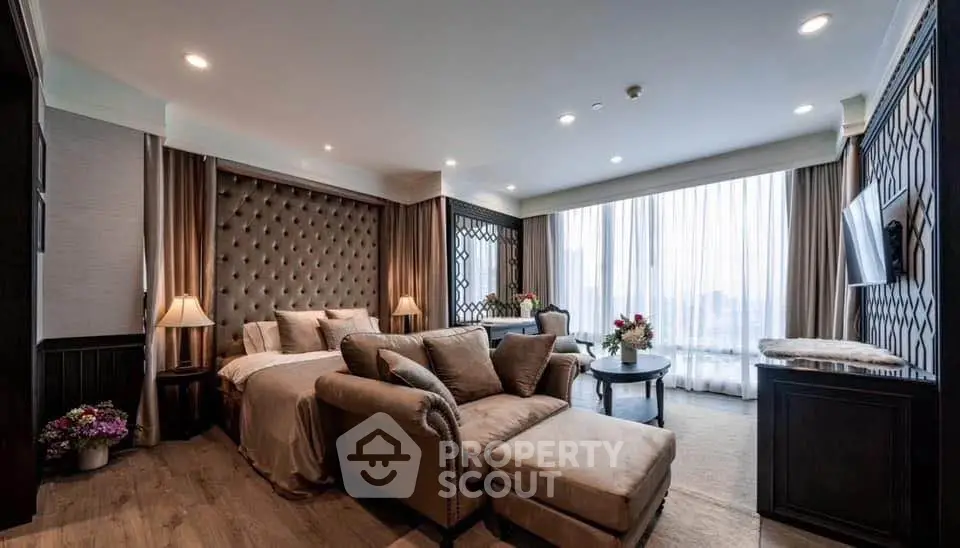 Luxurious living room with elegant decor and large windows offering natural light.