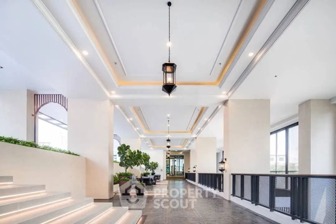Luxurious modern building entrance with elegant lighting and greenery