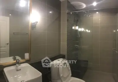 Modern bathroom with sleek fixtures and glass shower enclosure