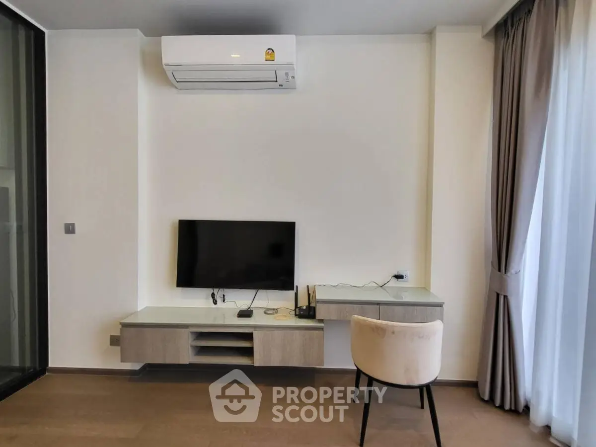 Modern living room with wall-mounted TV and air conditioning unit